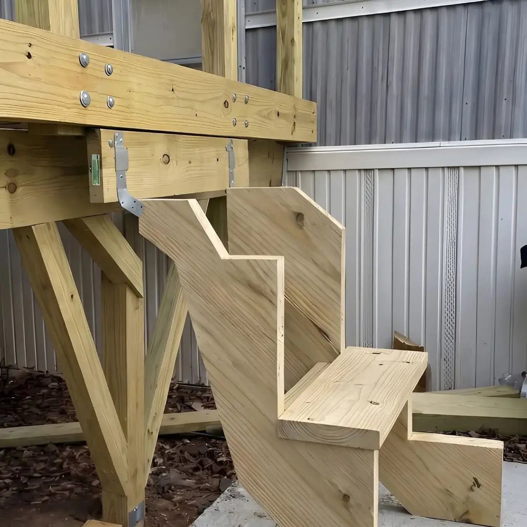 Deck Steps With Landing: 12 Ideas for Any Yard 5 Wooden deck steps showing a custom curved cut stair stringer attached to a timber frame.
