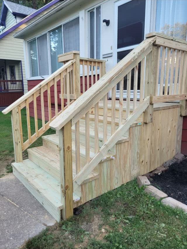 Deck Steps With Landing: 12 Ideas for Any Yard 10 Wooden deck steps with a landing and railings leading to a house entrance.