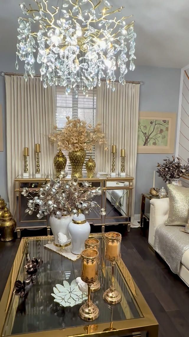 12 Decor for Winter After Christmas Ideas for a Cozy Home 11 Gold and silver winter decorations in a living room with a crystal chandelier and metallic floral arrangements.