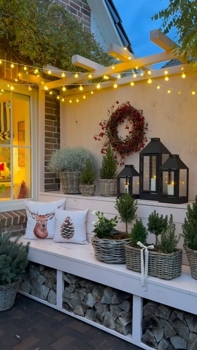 12 Decor for Winter After Christmas Ideas for a Cozy Home 4 Wicker baskets filled with small evergreen plants arranged on a white wooden outdoor bench.
