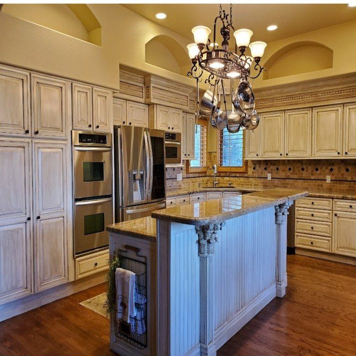 17 DIY Kitchen Island Ideas From Dressers to Live-Edge Slabs 10 Kitchen island with decorative corbels and beadboard paneling in a bright kitchen.