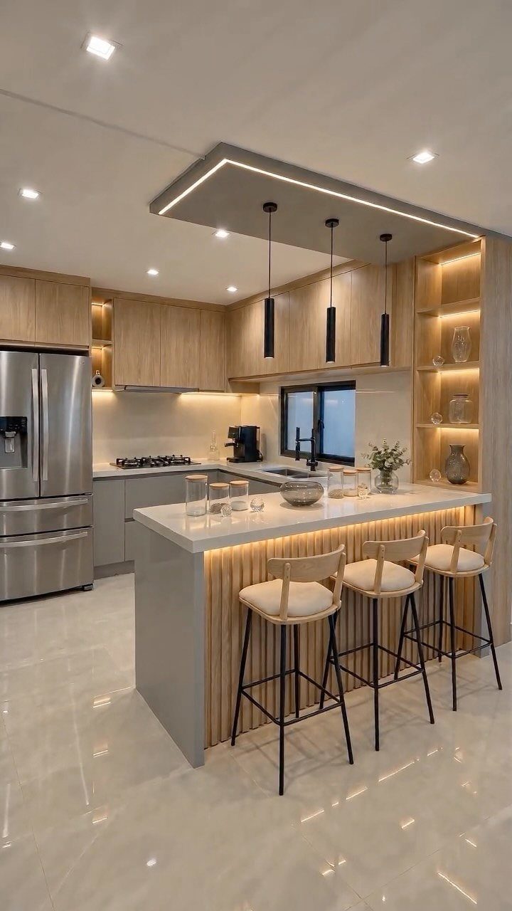 17 DIY Kitchen Island Ideas From Dressers to Live-Edge Slabs 11 Modern kitchen island with vertical wood slats, white countertop, and three minimalist bar stools.