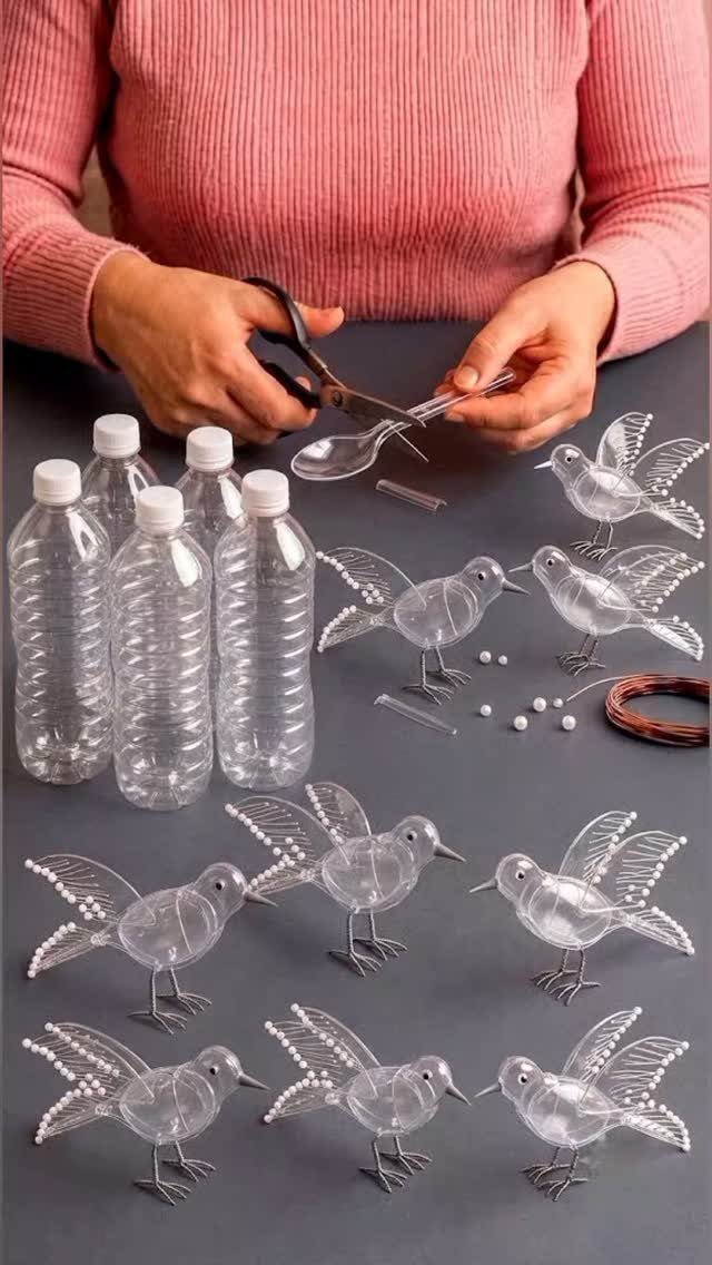 Hands using scissors to cut a plastic spoon near several recycled plastic bottle bird decorations.