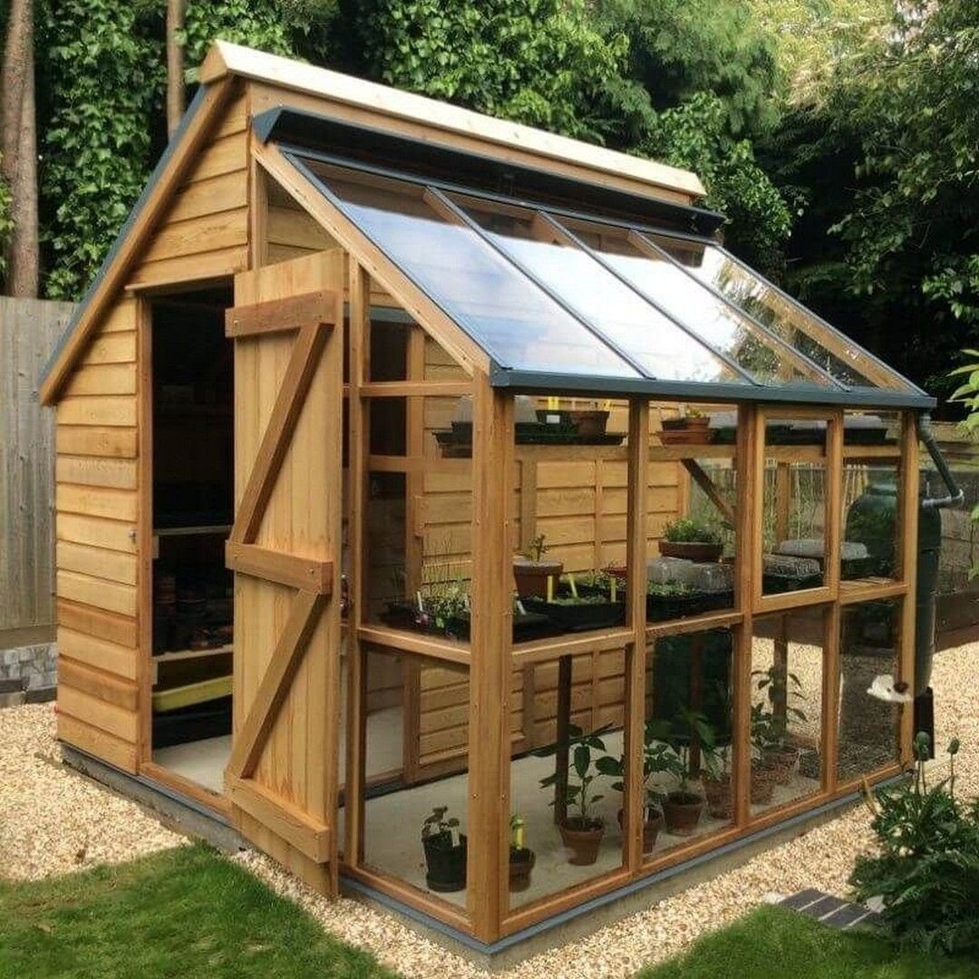10 Easy Greenhouse Ideas for Any Backyard and Budget 8 A wooden garden shed combined with a glass-paned greenhouse containing various potted plants.