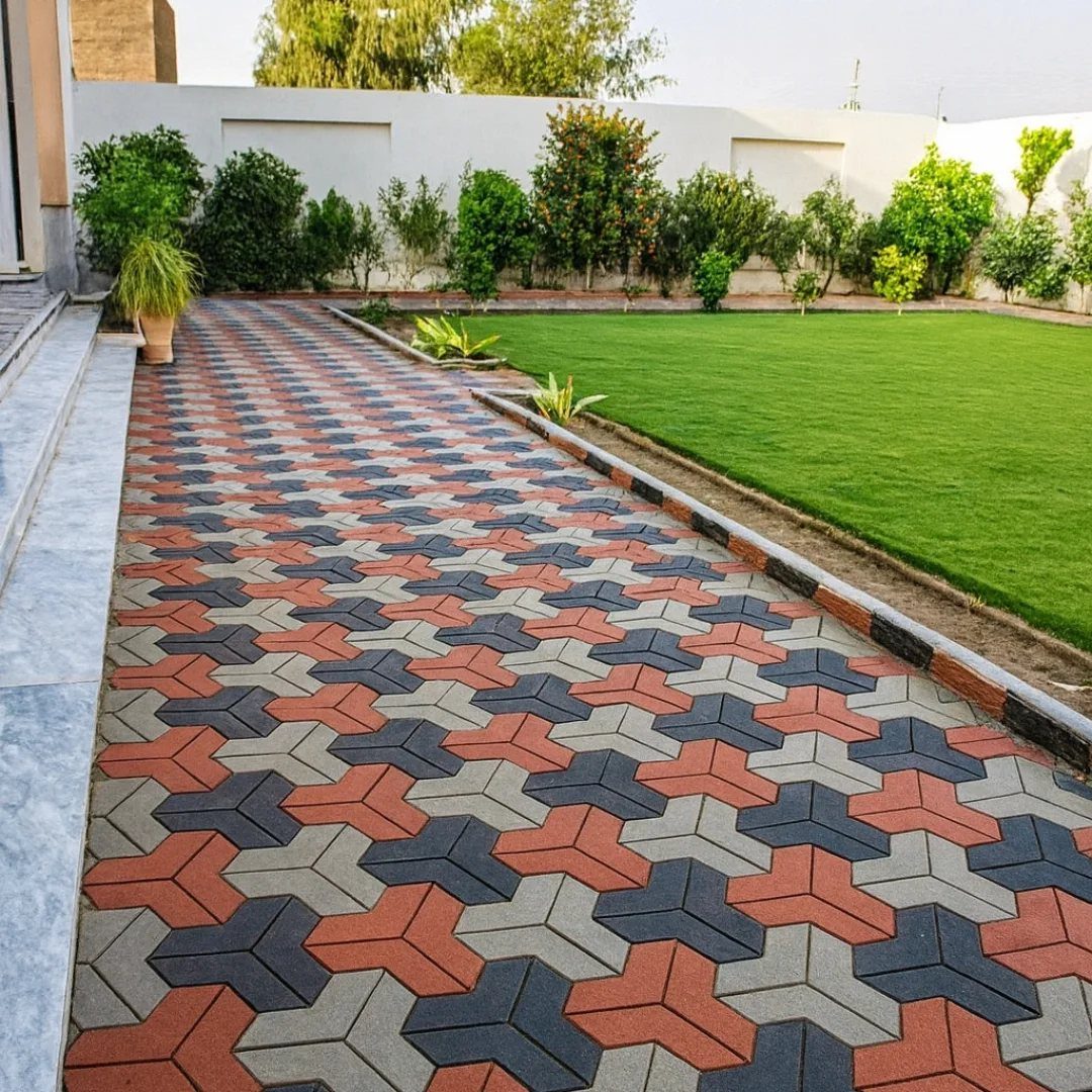 11 Landscaping Front Walkway Ideas: Flagstone to Paver & Modern Styles 3 Interlocking patterned pavers in gray and terracotta colors forming a walkway next to a green lawn.