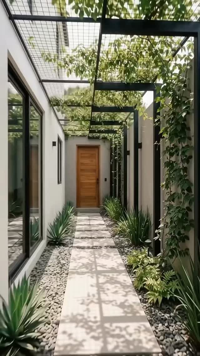 18 Yard Layout Ideas with Photos for Front and Back Spaces 4 Rectangular stone pavers form a walkway lined with river stones and climbing vines under a pergola.
