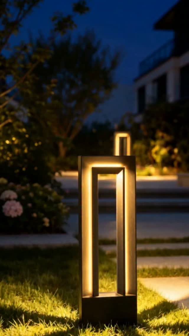 18 Yard Layout Ideas with Photos for Front and Back Spaces 2 Modern rectangular black pathway lights glowing warmly on a green lawn at dusk.